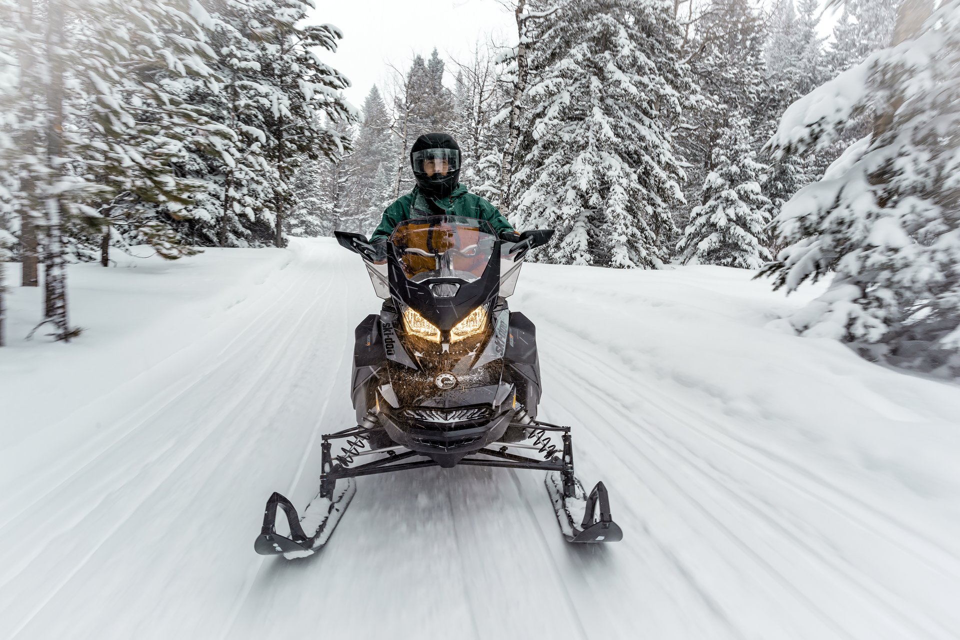 snowmobiling through trees